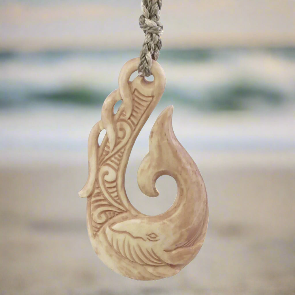 carved fishing hook of whale bone Maori Design Fish by Alex Sands silverferngallery and unwavering strength a powerful connection to the oceans vast wonders Matau (fish hook) Taonga. 1800